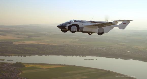 AirCar flying over rural landscape.