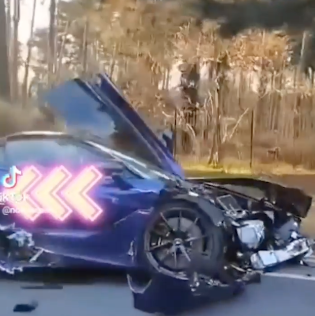 A wrecked blue McLaren supercar after a crash.