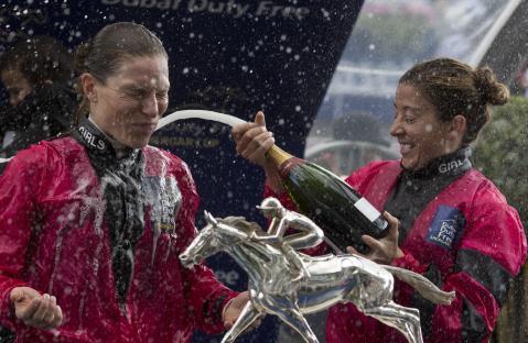 Jockey Hayley Turner sprays teammate Emma-Jayne Wilson with champagne after a race win.