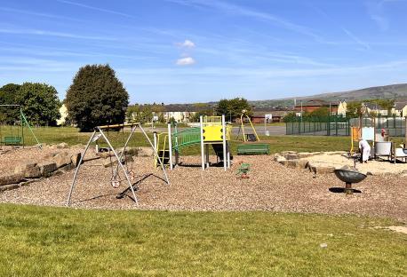 Playground with swings, slides, and other play equipment.