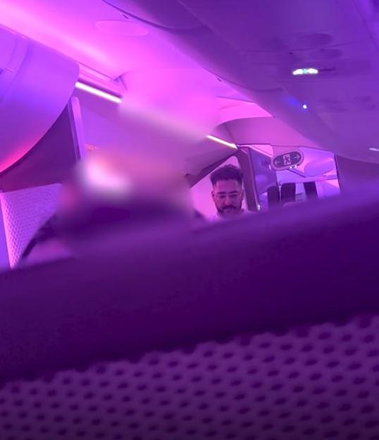 Man in airplane seat.