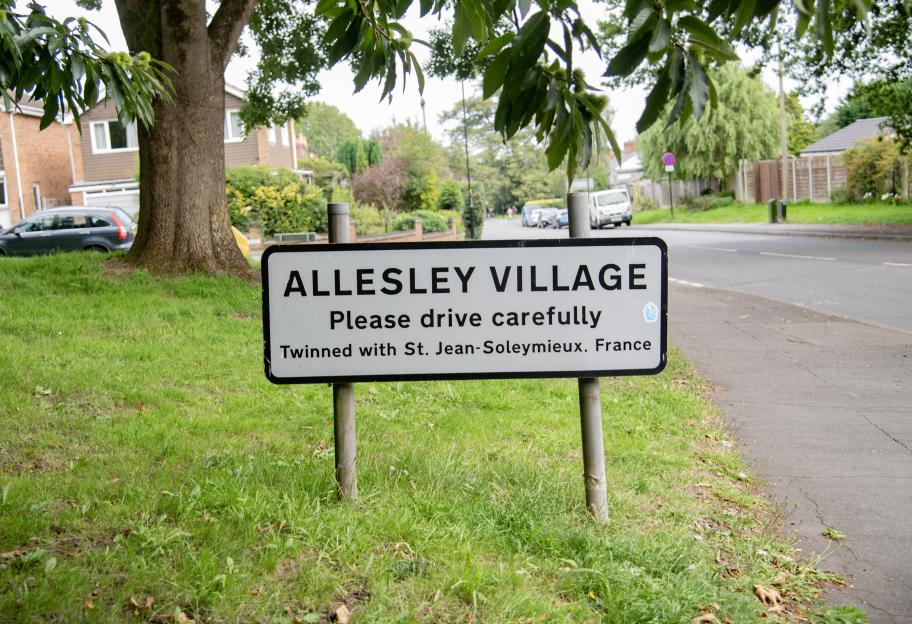 Allesley Village sign, twinned with St. Jean-Soleymieux, France.