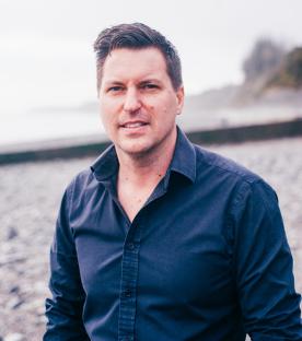 Portrait of a man smiling at the camera.