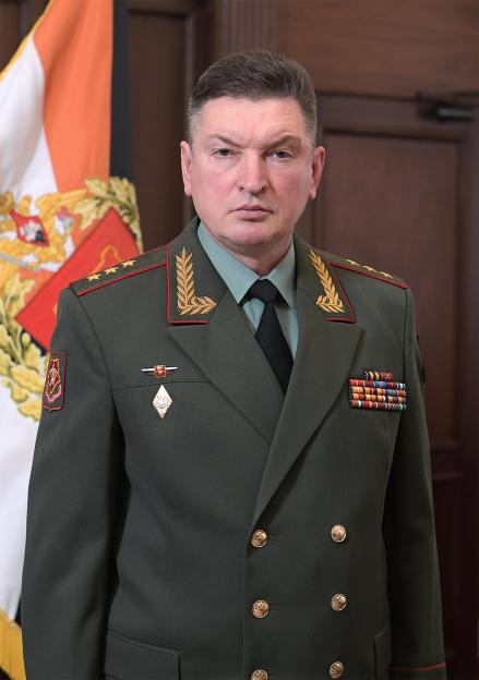 Colonel General Alexander Lapin in military uniform, standing in front of a flag.
