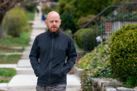 Jason Zimbler, known for his role in Clarissa Explains It All, walking down a residential street.