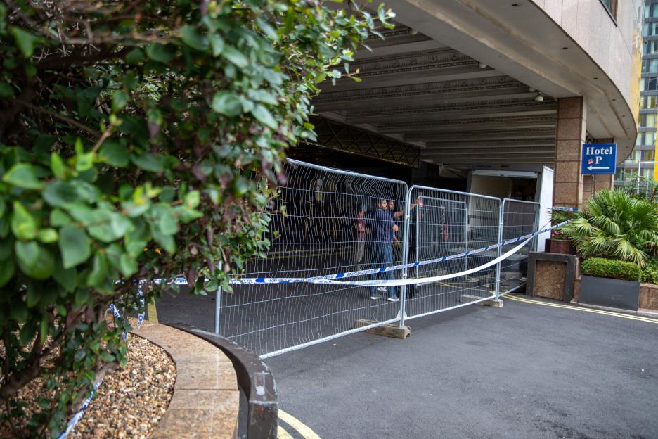 Britannia Hotel entrance blocked by police tape and a metal fence.