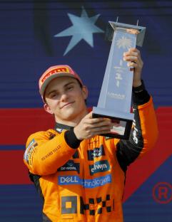 Oscar Piastri holding the Miami Grand Prix trophy.
