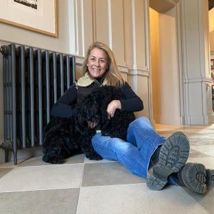 Woman sitting on the floor with two dogs.