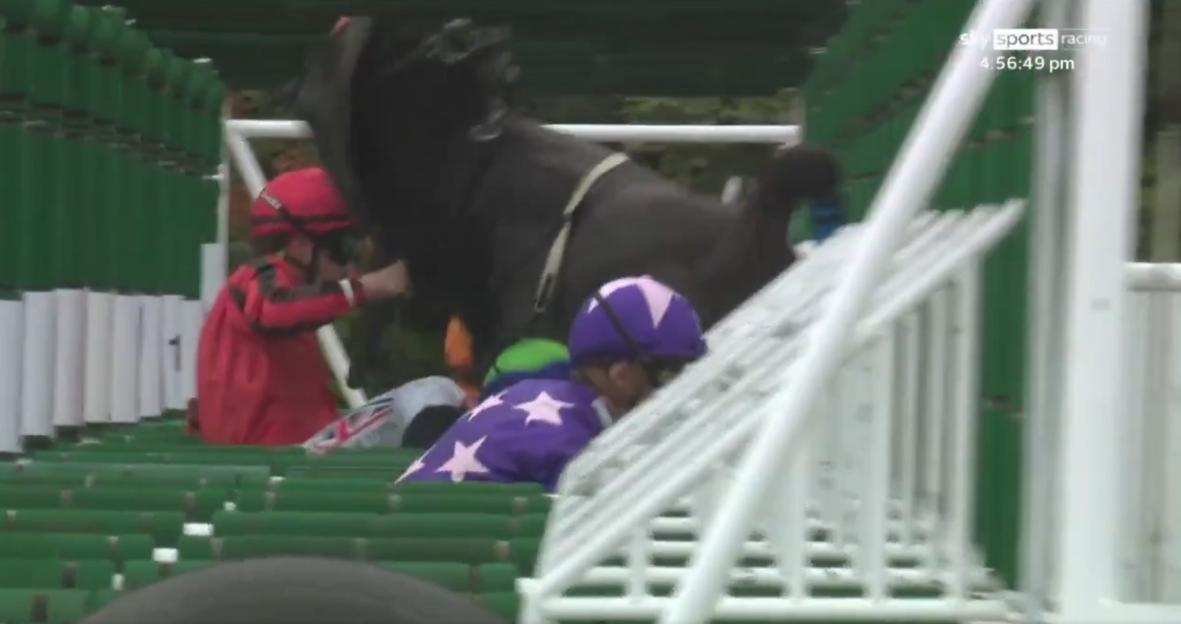 Jockeys falling at the starting gate.