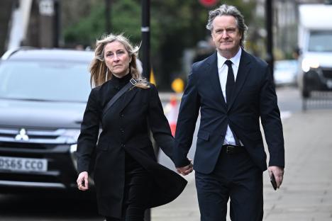 Fiona Phillips and Martin Frizell attending a funeral.