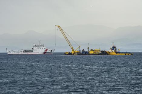 Italian Coast Guard ship assisting in the recovery of a sunken superyacht.