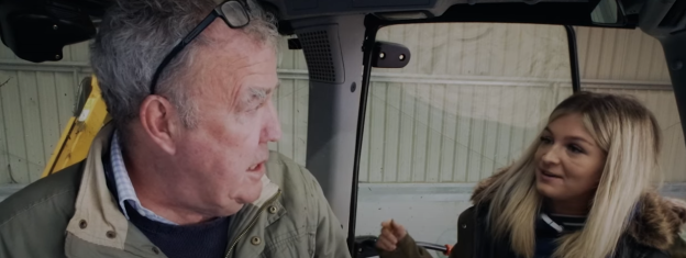 Screenshot of a man and a woman in a vehicle.