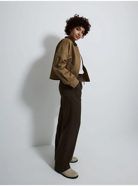 Woman wearing brown jacket and pants.