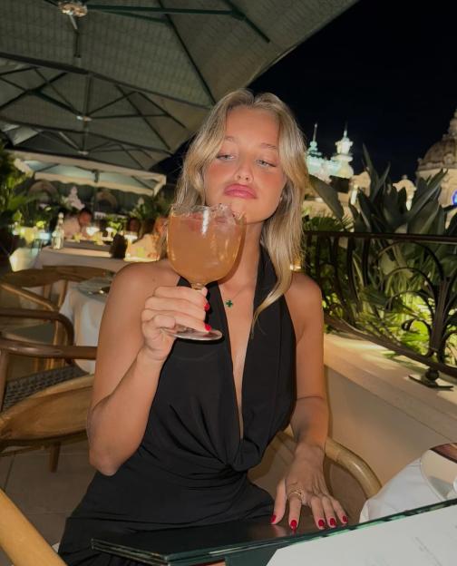 Woman holding a cocktail glass.