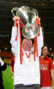 Sir Alex Ferguson holding the UEFA Champions League trophy.