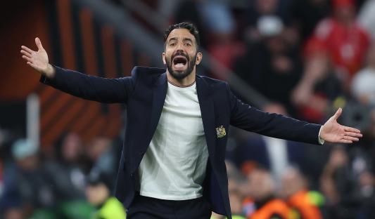 Frustrated soccer manager with arms outstretched.