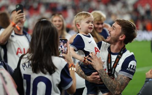 James Maddison of Tottenham Hotspur celebrates a Europa League victory with his son.