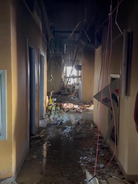 Flooded hallway of a bombed Kyiv apartment building.