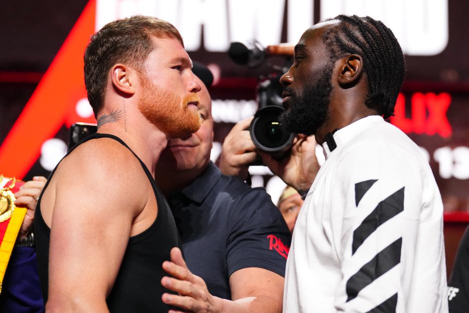Canelo Alvarez and Terence Crawford facing off at a press conference.