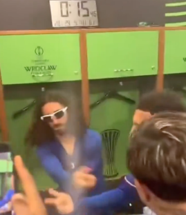 Screenshot of people celebrating in a locker room.