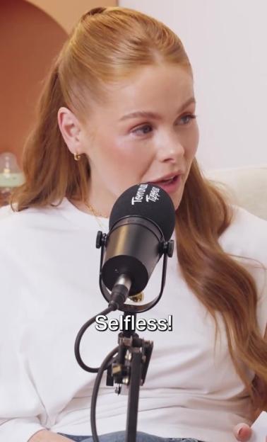 Olivia Bowen speaking into a "Tommee Tippee" branded microphone with the word "Selfless!" superimposed on the image.