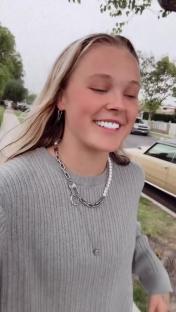 JoJo Siwa wearing a necklace and earrings.