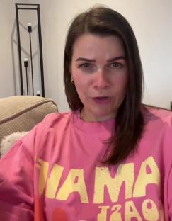 Woman in pink sweatshirt explaining why she uninvited her family from her wedding.