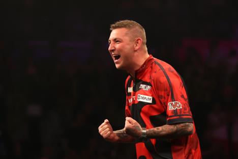 Nathan Aspinall celebrating a darts victory.