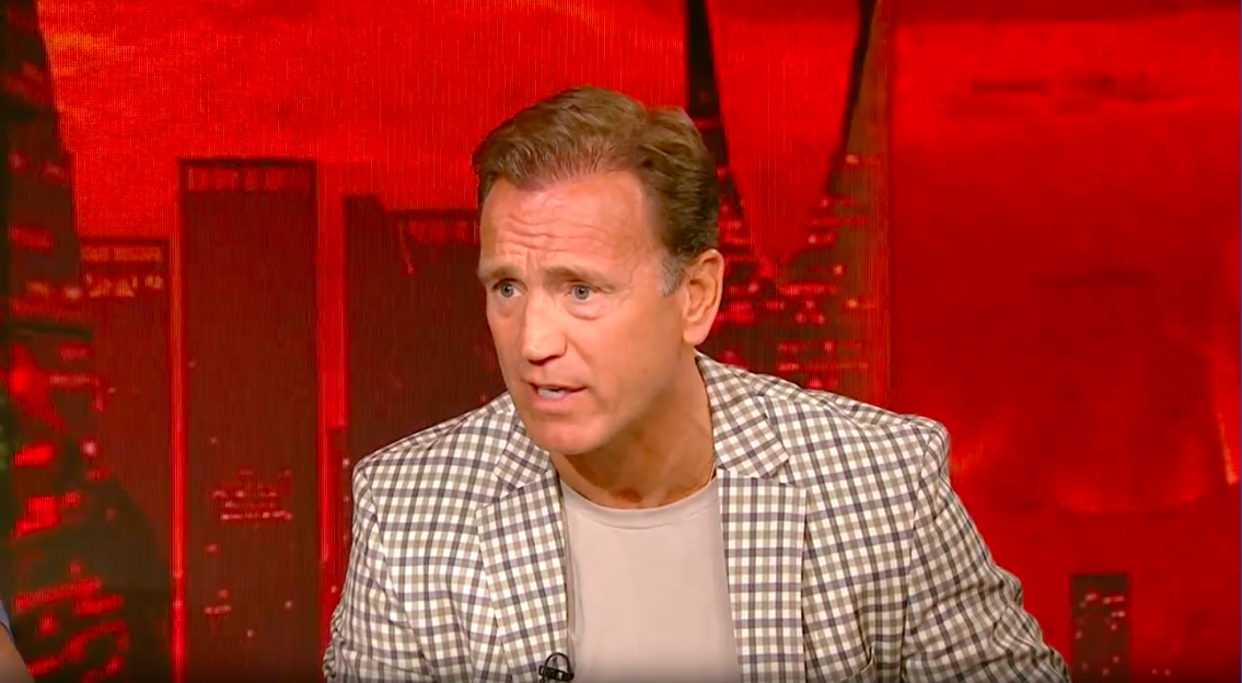 Screenshot of a man speaking.