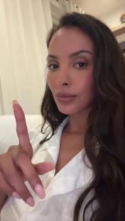 Maya Jama holding up her index finger.