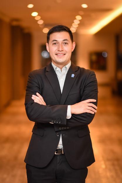 Andrew Wasuwongse, director of International Justice Mission Thailand, stands with arms crossed, smiling.