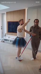 Sam Thompson mopping the floor while wearing a tutu.