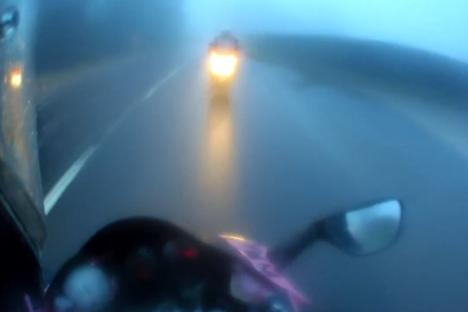 Horror moment motorcyclist smashes head-on into another biker during dangerous overtake on rain-soaked road