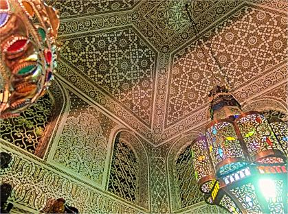 Ornate ceiling and hanging lanterns in Agadir, Morocco.