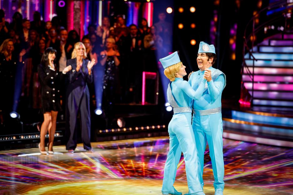Ross King and Jowita Przystal dancing in light blue outfits with matching hats on Strictly Come Dancing.