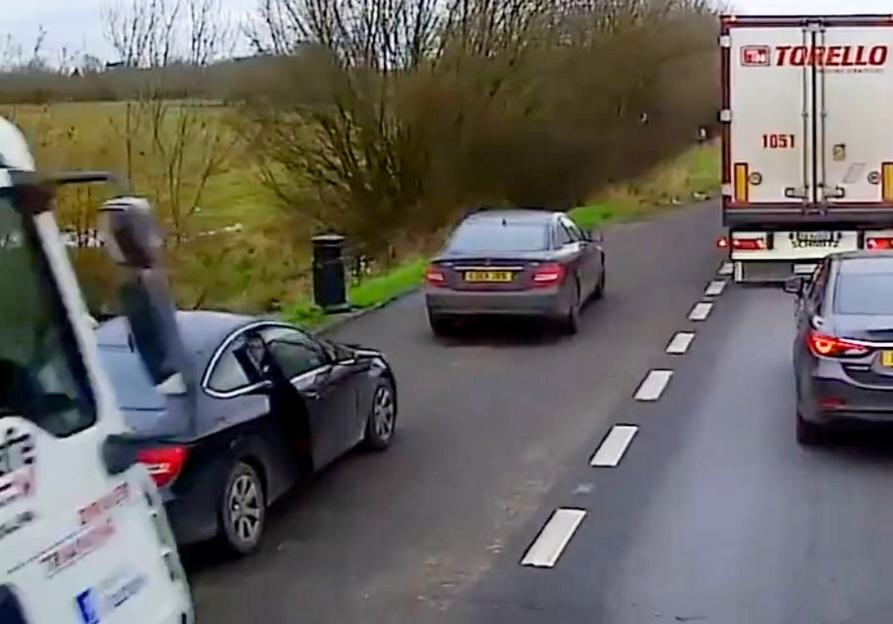 Dashcam footage of a lorry colliding with two parked cars in a layby.