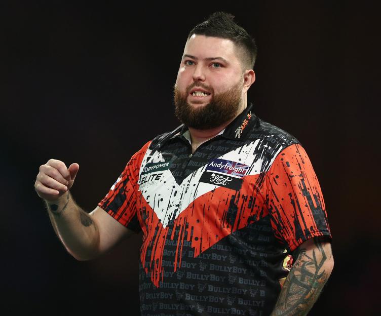 Michael Smith of England reacting during a darts match.