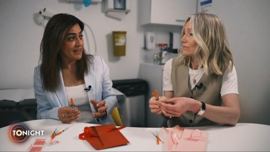 Two women discussing weight-loss drugs in a medical setting.