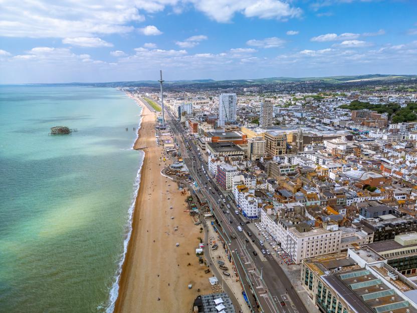 Aerial view of Brighton, UK, showing the beach, sea, and cityscape.