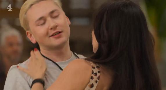 A woman touching a man's shoulder.