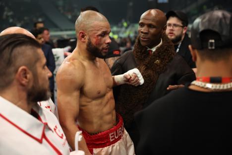Chris Eubank Jr. with his father after a boxing match.