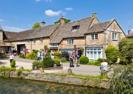 Bourton-on-the-Water's Cotswold Motor Museum and river.