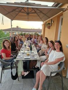 Group of people seated at an outdoor table.