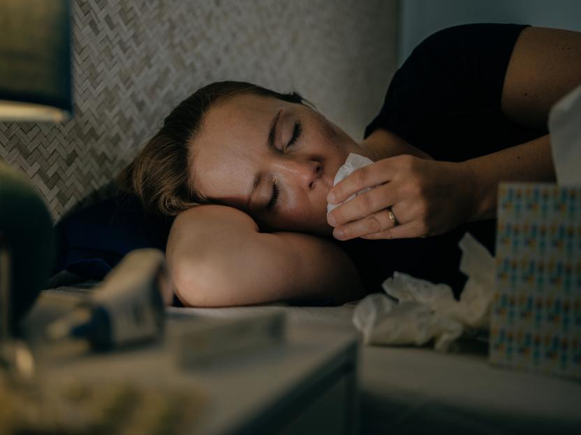 Ill woman using tissue paper.