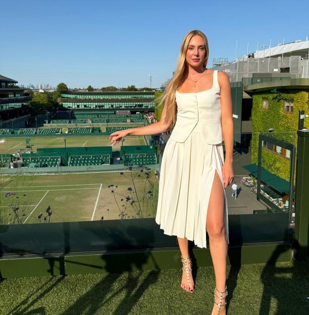 Woman in white outfit at Wimbledon.