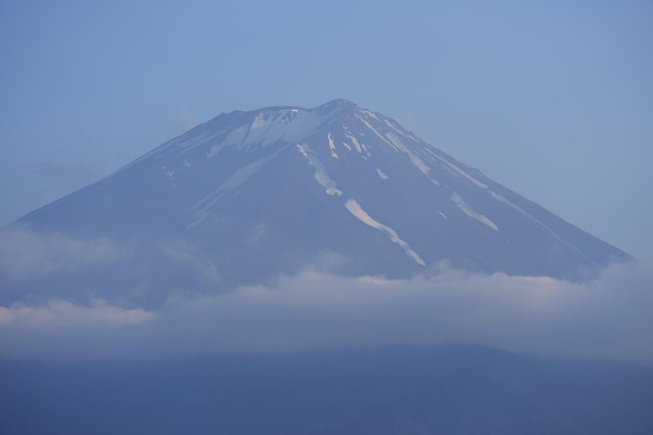 Mount Fuji partially obscured by clouds.