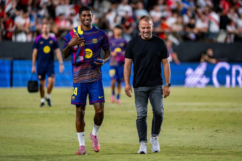 Marcus Rashford and Hansi Flick of FC Barcelona on the field.