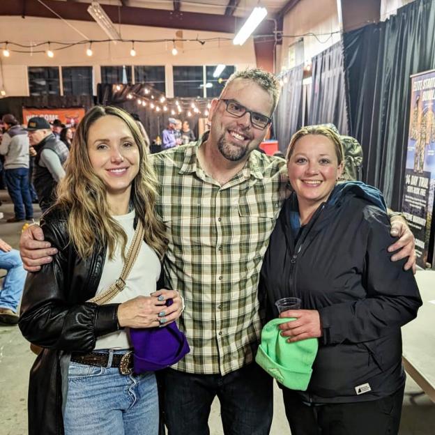 Photo of three people posing for a photo.