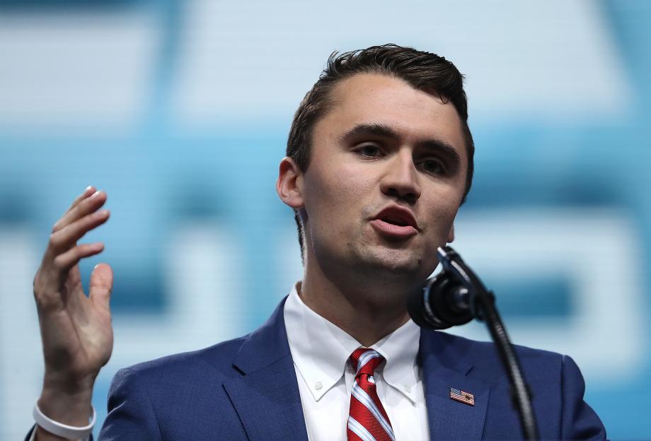 Charlie Kirk speaking at a podium.