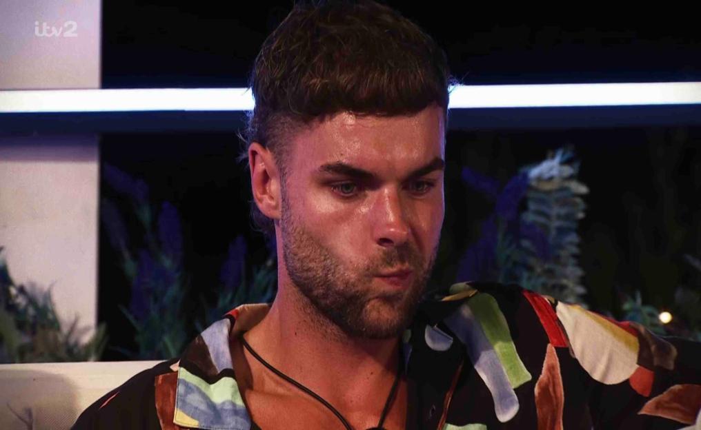 Screenshot of a man from Love Island looking pensive.